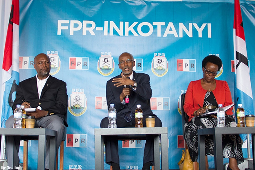 Rwanda Patriotic Front (RPF-Inkotanyi) Secretary-General Francois Ngarambe (C) addresses the media as party commissioner Wellars Gasamagera, who will be the media relations officer....