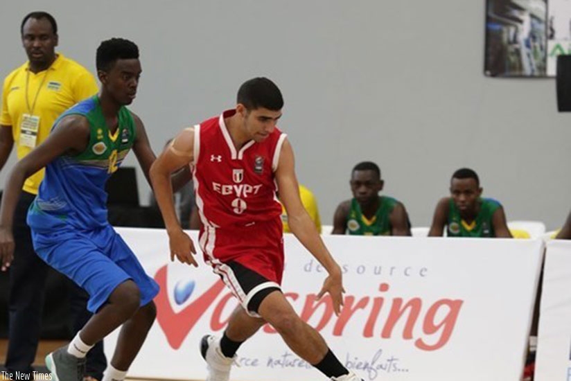 Rwanda's point guard Steff Mucyo Rukundo tries to challenge an Egyptian player during the game yesterday. Rwanda lost the game 45-101. Courtesy
