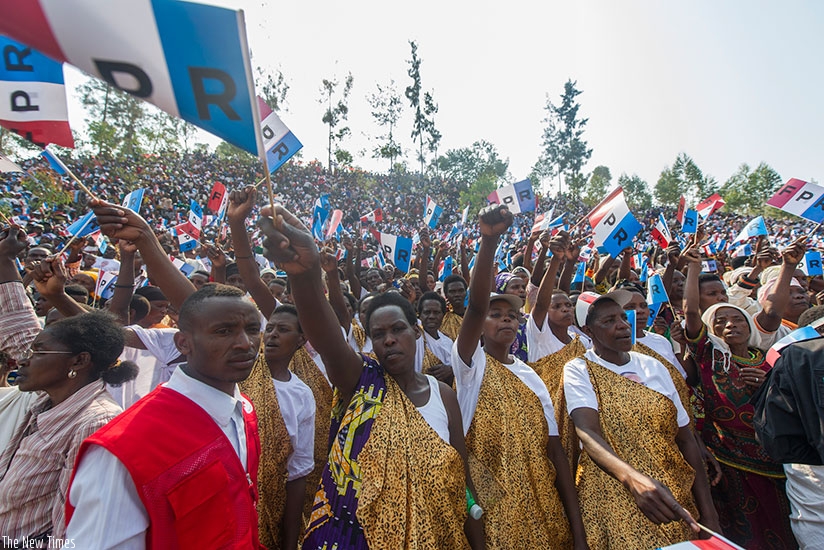 Residents of Nyaruguru raise RPF flags as they listen to RPF presidential flag bearer Paul Kagame yesterday. Thousands turned up to show their support on day 2 of the presidential ....
