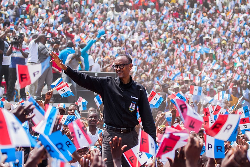 Incumbent President Kagame greets residents of Nyaruguru after arriving in the Southern province during Day 2 of the presidential campaigns yesterday. The RPF presidential flag bea....