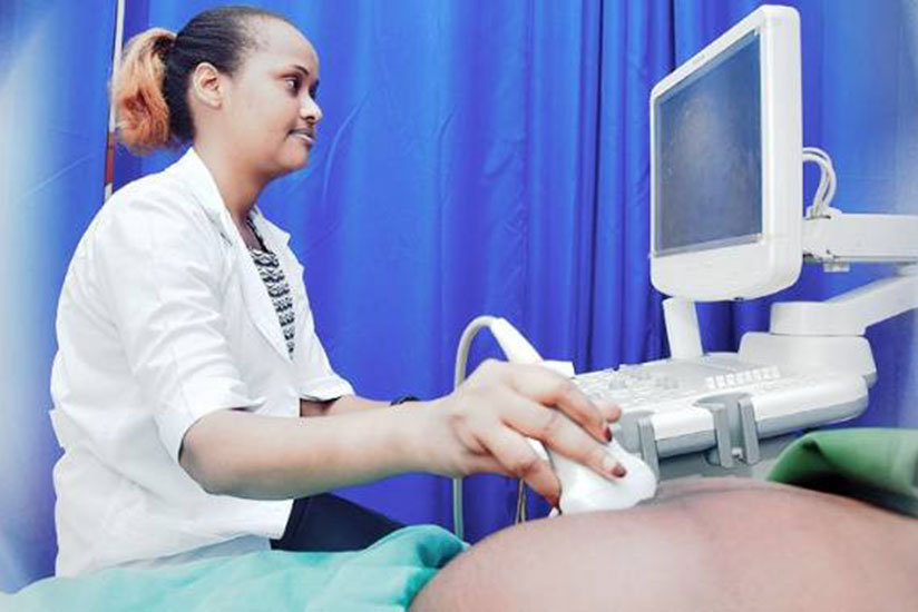 A radiology specialist examining a patient for presence of ovarian cysts with a modern ultrasound scan at Rwanda Military Hospital. (Courtesy photo)