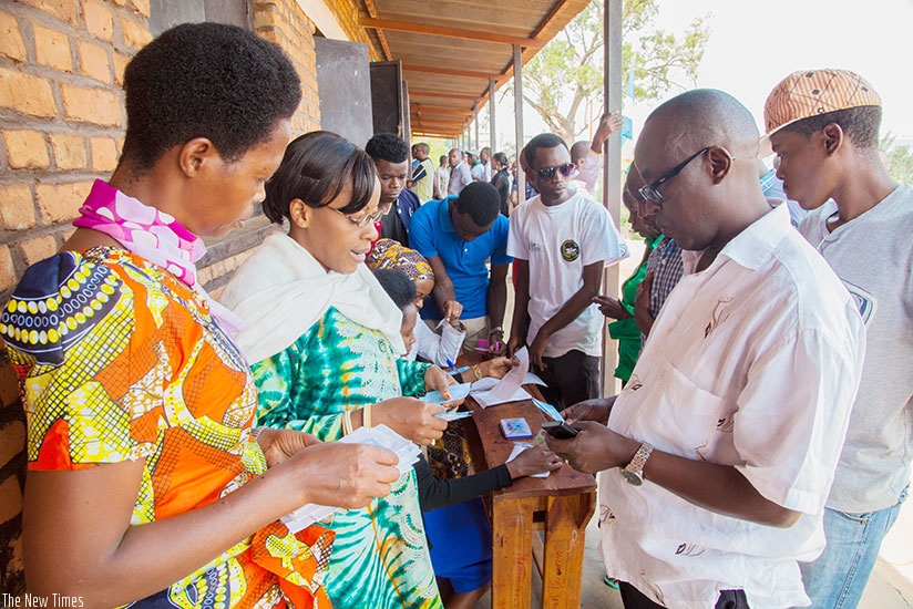 Citizens search for their voter cards at Ecole Sainte Famille polling station in Kigali  File  