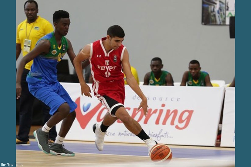 Rwanda's point guard Steff Mucyo Rukundo tries to put a challenge on an Egyptian player during the first round game (Courtesy)