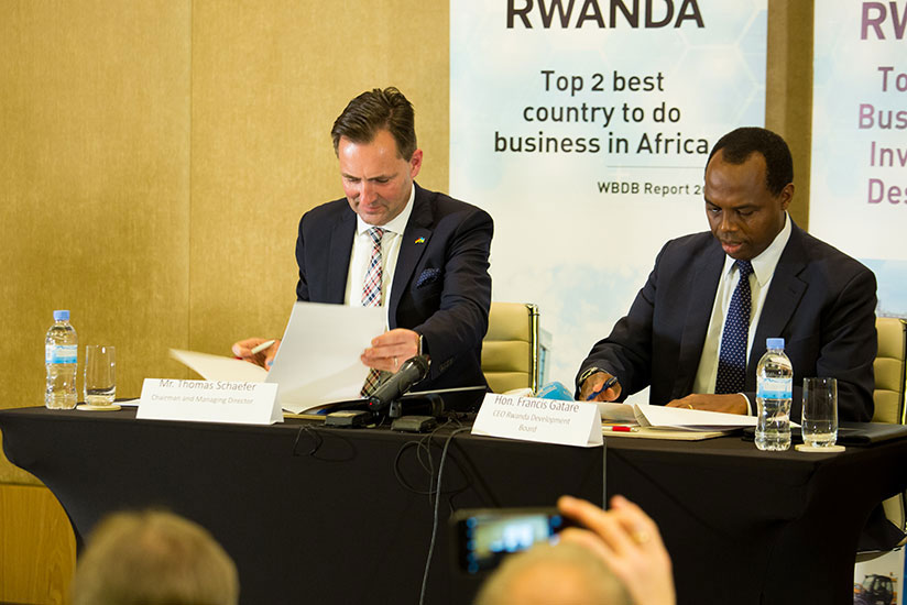 Thomas Schafer, the Chief Executive Officer of Volkswagen South Africa, signs a memorandum of understanding with former RDB Chief Executive Officer, Francis Gatare, last year for t....