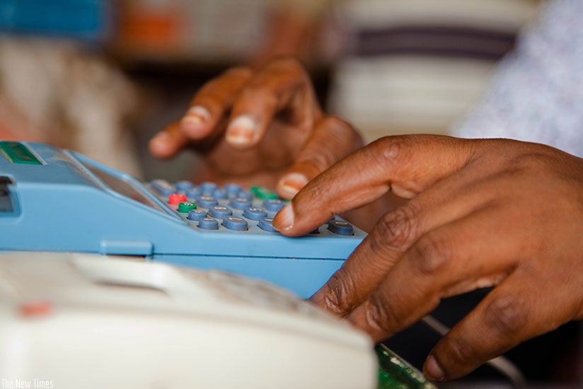 A trader transacts business using a billing machine at Mateos.TKisambira