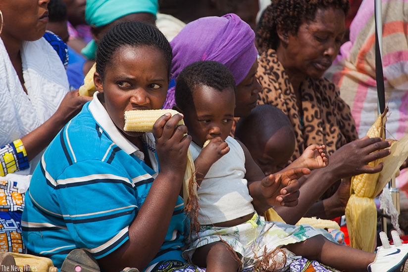 Residents of Nyanza District share maize during umuganura celebrations last year. File.