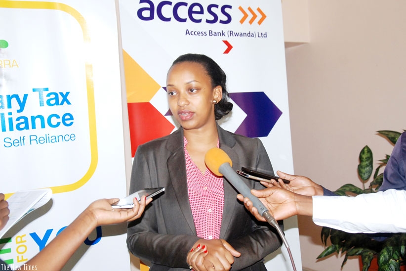 Gloria Asiimwe Bwiza, the Head of Personal and Business Banking in Access Bank speaking to Journalists.
