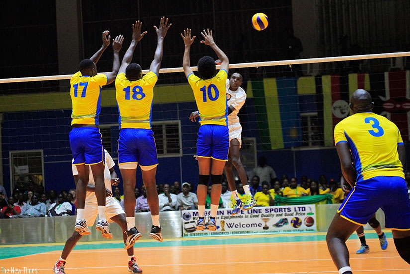 The national volleyball team players try to block a spike from a Kenyan player during the final game of the just - concluded Zone V at Amahoro indoor stadium. Sam Ngendahimana