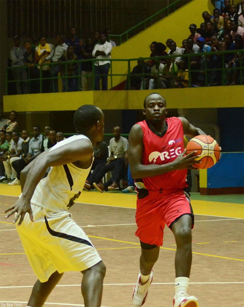 REG's Patrick Habiyambere tries to go past Patriot's Aristide Mugabe during the game one of the ongoing playoffs finals series at Amahoro indoor stadium. Sam Ngendahimana