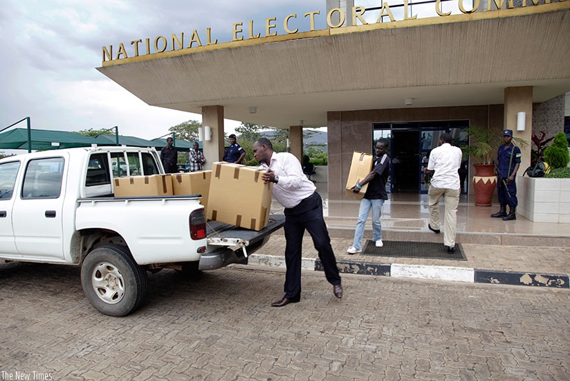 NEC staffers load voters kits on a truck during the 2013 elections. File.