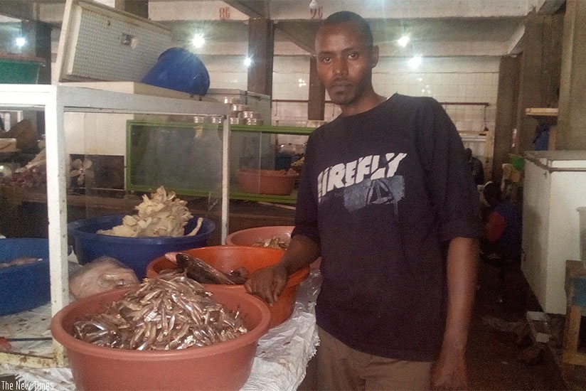 Joseph Ntunga, a fish trader in Huye market, attributed the rise in fish prices to low supply. / Remy Niyingize.