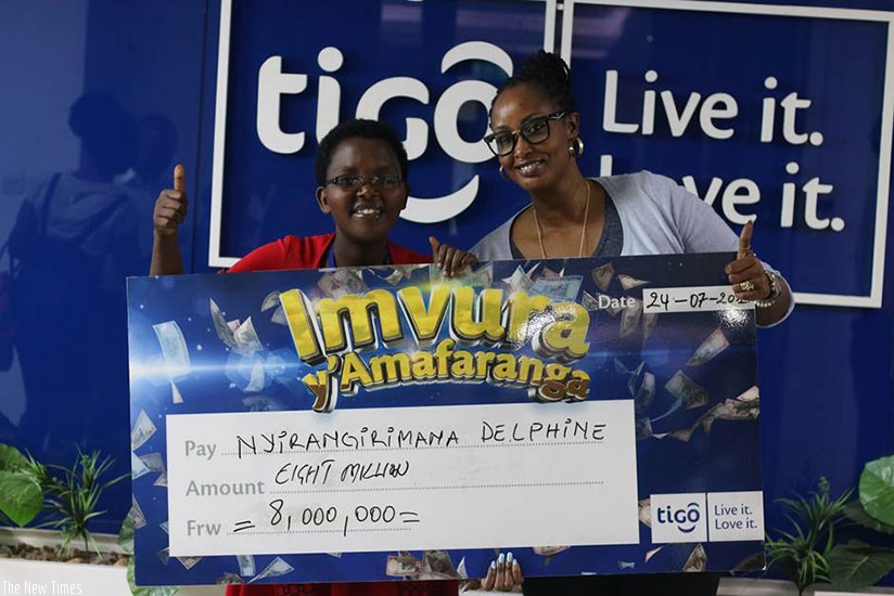 Irangaza (left) after receiving the dummy cheque from Tigo deputy CEO, Chantal Umutoni Kagame. / Courtesy.