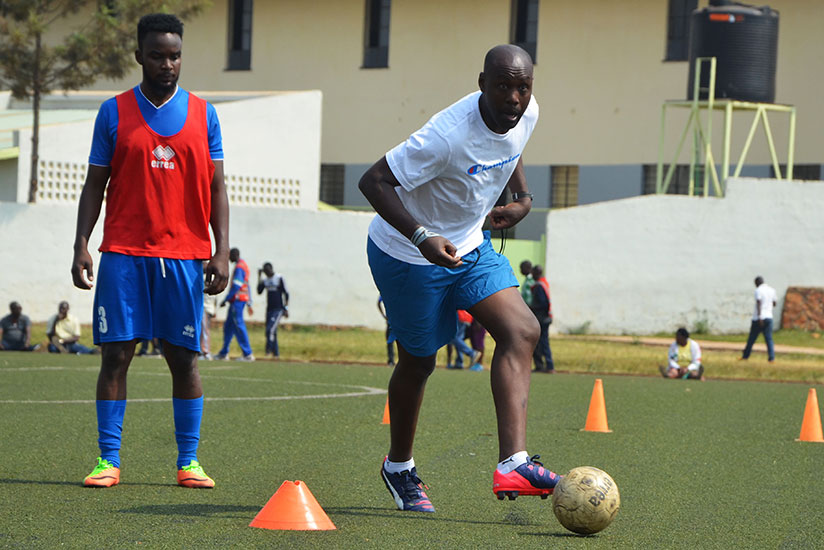 Former APR and Amavubi captain Olivier Karekezi shows Rayon Sports' players how it's done during his first training session on Friday at Mumena Stadium. / Sam Ngendahimana
