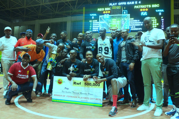 Patriots basketball club players and officials celebrate after winning this year's playoff finals against REG on Saturday evening at Amahoro Indoor Stadium. / Courtesy