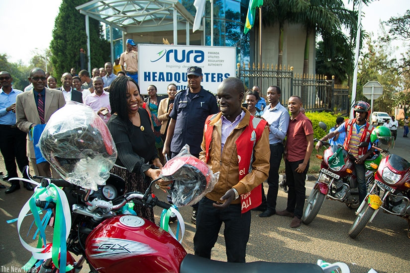 Donat Ndayiramiye, receives a brand new motorcycle from Beata Mukangabo head of corporate affairs. (Photos by Timothy Kisambira)
