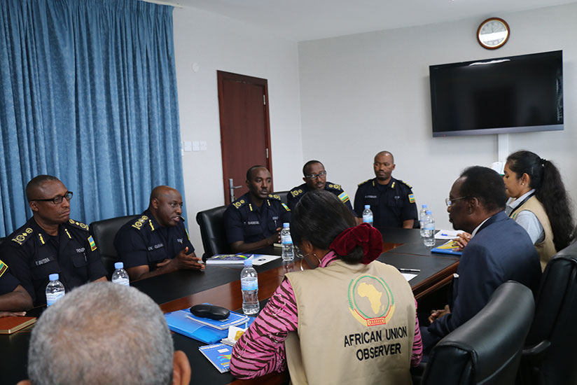 IGP Gasana (second from left, background), flanked by other senior Police officers, speaks during the meeting with the AU observers in Kigali yesterday. Courtesy.