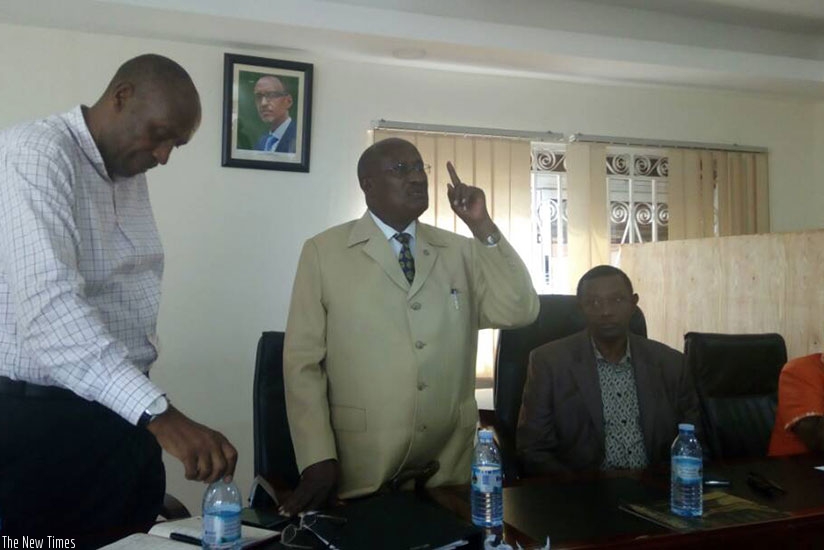Frank Rusanganwa, an elder of the Rwanda community in Uganda addresses polling officials that will conduct elections today. High Commissioner Mugambagye is seated (2nd right). By G....