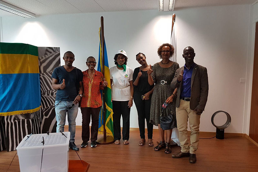 Members of the Rwandan community in Switzerland flash their voter ink-stained thumbs after casting their ballots earlier today. Courtesy.