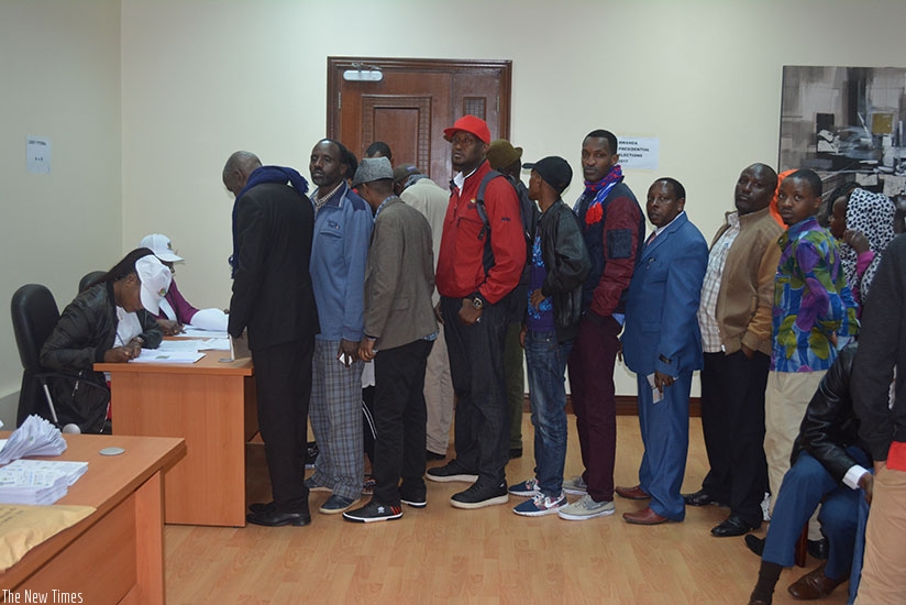 Members of Rwandan community in Nairobi line up as they wait to cast their vote