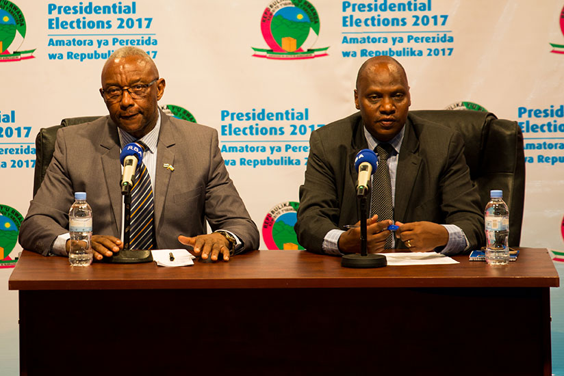 Prof. Kalisa Mbanda (L), the Chairperson of the National Electoral Commission, and Charles Munyaneza, the commission's executive secretary, during the release of the preliminary el....