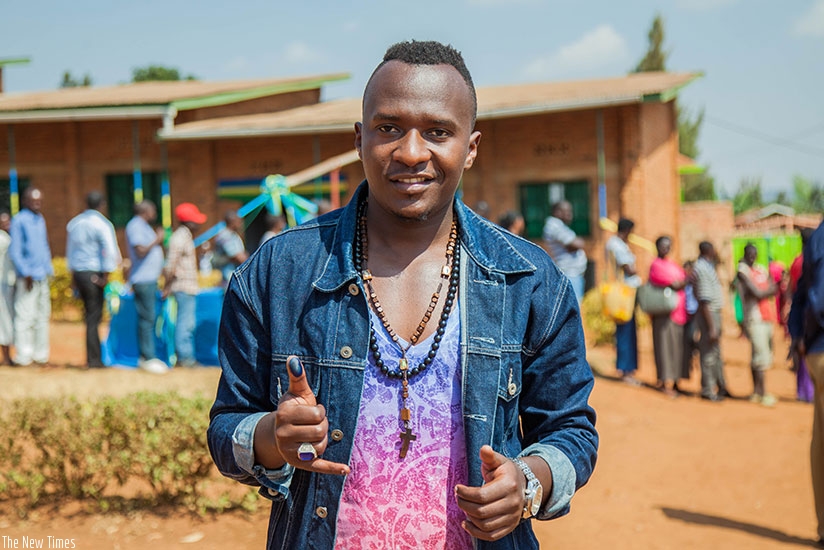 Platini Nemeye of Dream Boys flashes his ink-stained thumb after voting at College George Fox Kagarama. N. Imbabazi.