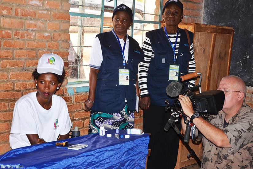 COMESA observers watch Habineza vote in Kimironko yesterday. Sam Ngendahimana.