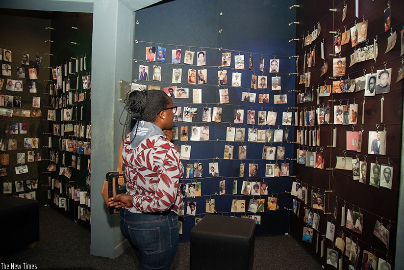 A survivor looks at pictures of victims inside Kigali Genocide Memorial Centre, Gisozi, recently. Nadege K. Imbabazi. 