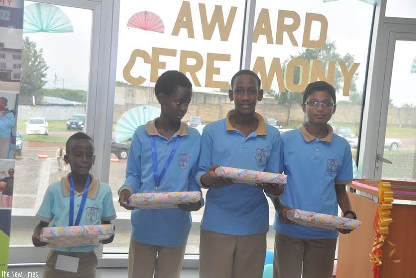 Being smart yields to success.  Pupils pose for a photo with their prizes after winning a competition. / Dennis Agaba