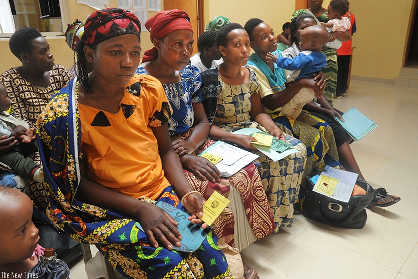 Mothers hold their Mutuelle insurance cards at Gashora health centre in Bugesera District. File.