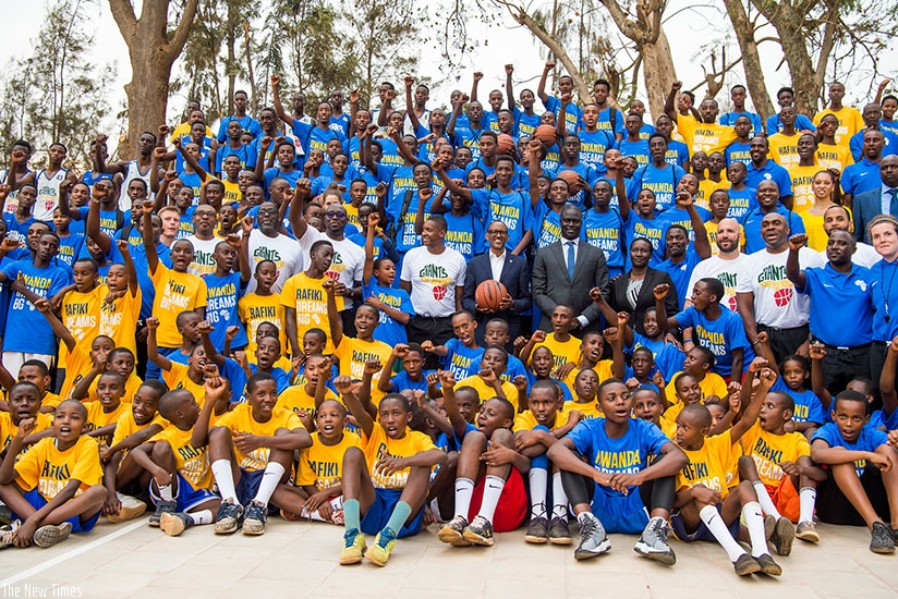 President Paul Kagame, Masai Ujiri, NBA Africa Head, Amadou Fall, and Culture and Sports Minister Julienne Uwacu pose with children at the launch of Giants of Africa Basketball Cou....