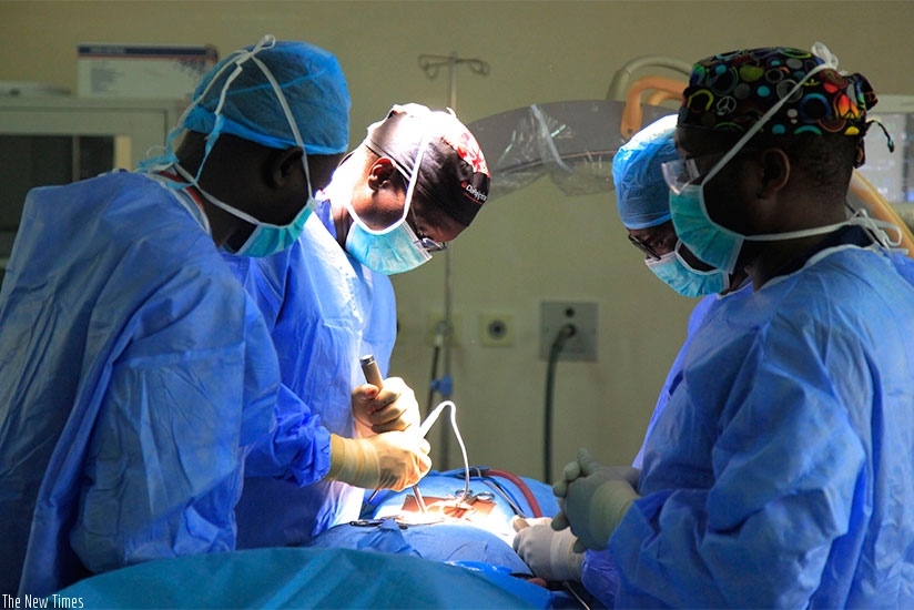 Prof. Butera (C) leads other doctors as they operate on a patient at King Faisal Hospital Kigali. Sam Ngendahimana. 