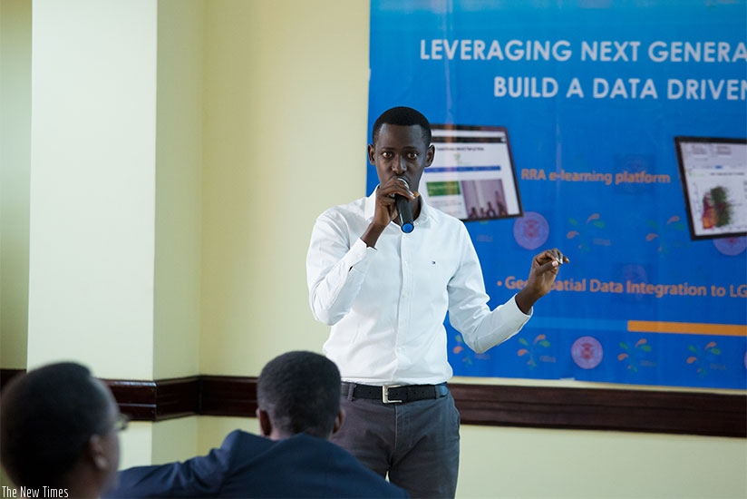 Darius Mico, one of the software developers, gives a presentation during the unveiling of the five applications in Kigali on Friday. Timothy Kisambira. 