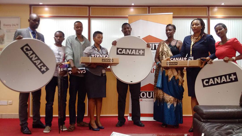 Equity Bank's Niragira (second right) poses for a photo with some of the clients and their prizes. / Joan Mbabazi