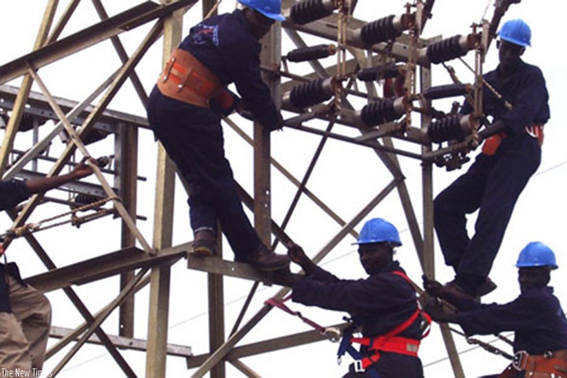 Technicians from Rwanda Energy Group service an electricity pylon in Kigali. File