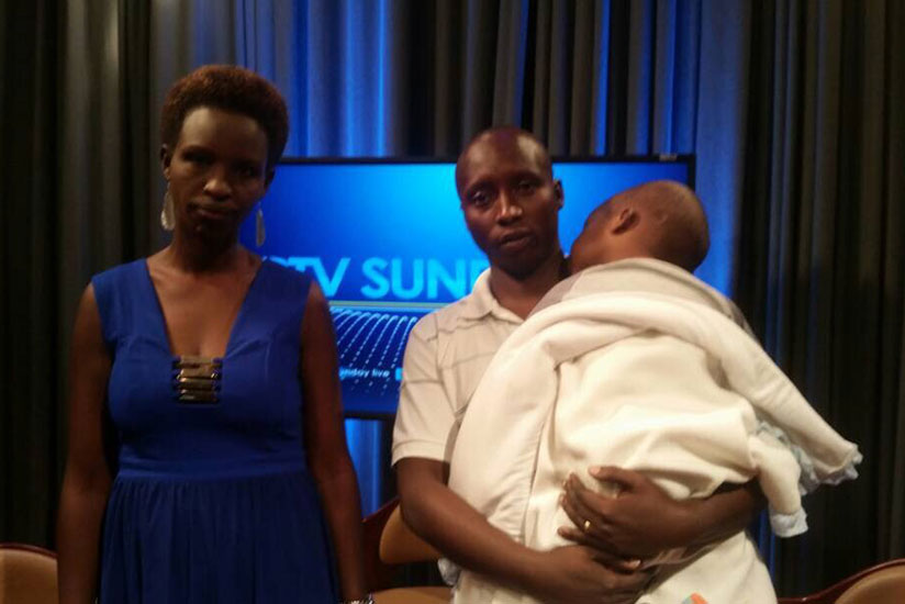 Isheja Gasana, 4, who needs surgery to treat his brain tumor with his parents.. / Courtesy photorn