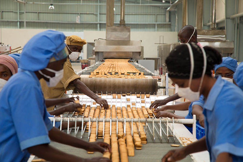 Workers at ADMA Biscuit factory in Kigali sort biscuits. / Timothy Kisambira