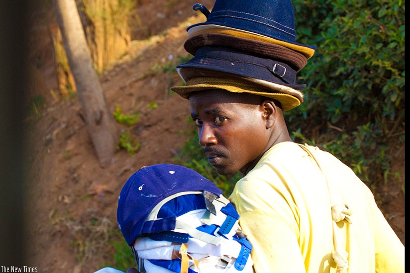 A vendor sells caps in Nyamirambo suburb of Kigali. Timothy Kisambira.