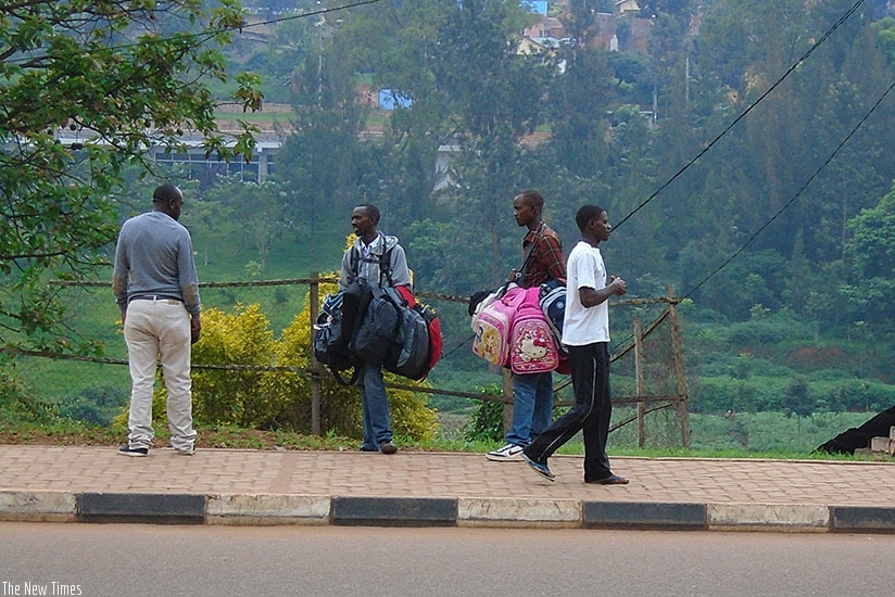 A man bargains with backpack vendors in Kigali. (Steven Muvunyi)