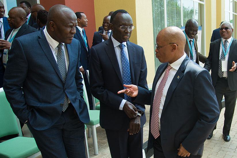 Chief Justices Sam Rugege of Rwanda (C), Abdulai Charm of Sierra Leone (L), and Mogoeng Mogoeng of South Africa chat after the opening session of a three-day continental conference....