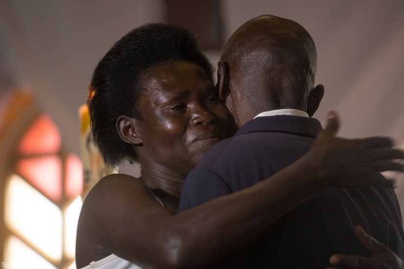 A Genocide survivor, Anne-Marie Uwimana, hugs Celestin Habinshuti, a former Genocide convict who brutally killed two of her children during the 1994 Genocide against the Tutsi. Thi....