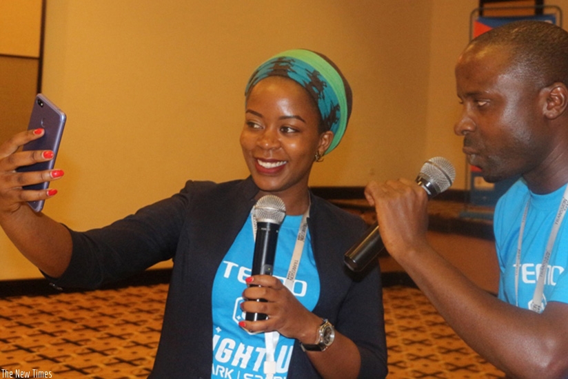 A TECNO salesperson takes  a selfie using the new device during the launch on Thursday.   / Eddie Nsabimana.