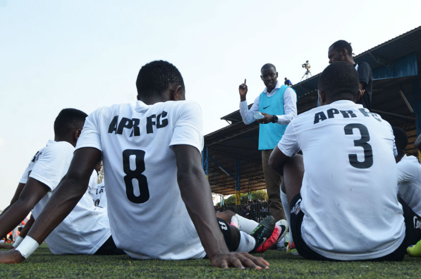 APR FC players listen to head coach Jimmy Mulisa in half time at Kicukiro Stadium last season. / Sam Ngendahimana