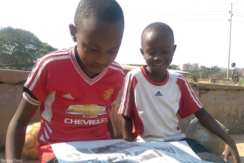 Pupils reading a newspaper after school. Reading stories equips you with several important life skills. / Dennis Agaba