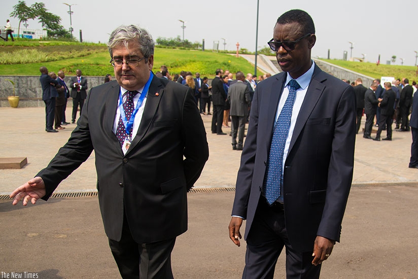 Mehmet Raif Karaca, the Turkish ambassador  to Rwanda (L) chats with Kabarebe on the sideline of the meeting in Kigali. T. Kisambira. Timothy Kisambira. 