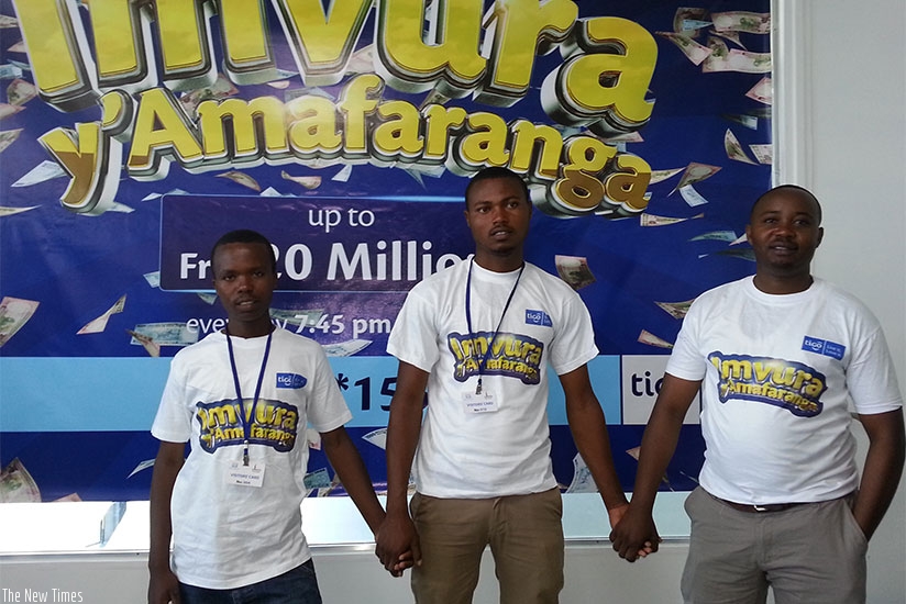 Habakurema (left) poses for a picture with previous jackpot winners, Faustin Nkundayesu (middle) and Jean Pierre Usabuwera. / Marie Anne Dushimimana.