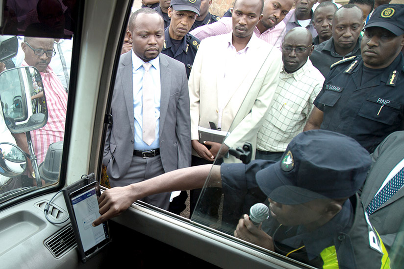 A traffic officer shows government officials how speed governors work in public vehicles. / File