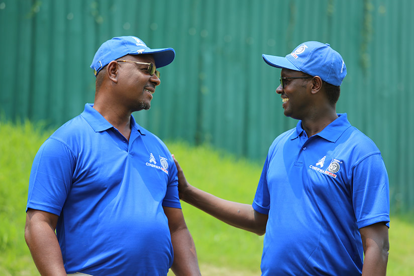 Njombo Lekula, the outgoing MD of International Operations at PPC the partnering company of CIMERWA shares a light moment with Emmanuel Hategeka, the Chief Operating Officer of Rwa....