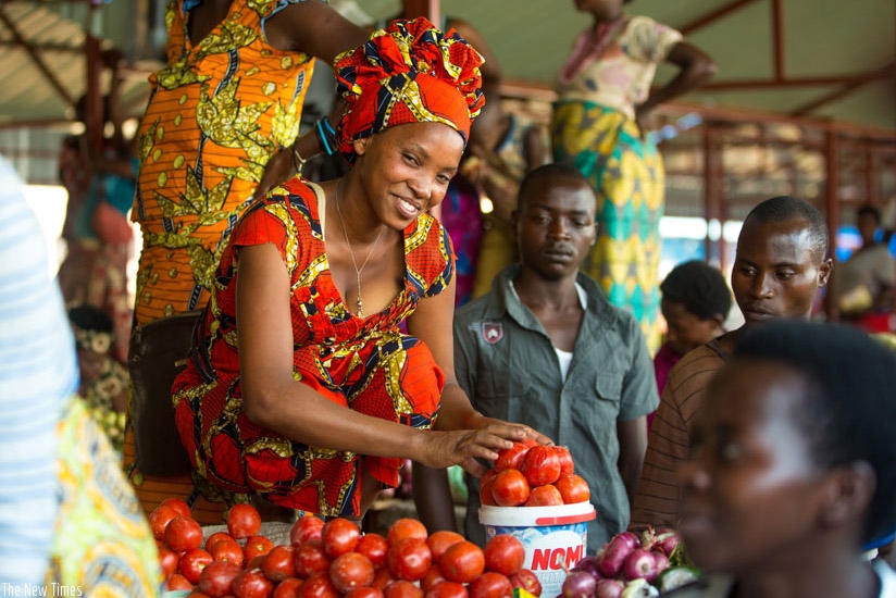 A former vendor sells tomatoes at the new Nyabugogo market. Timothy Kisambira. 