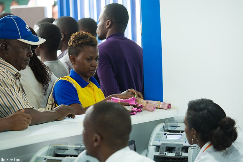 Customers open savings accounts at BK stand at Gikondo Expo Grounds yesterday. T. Kisambira.