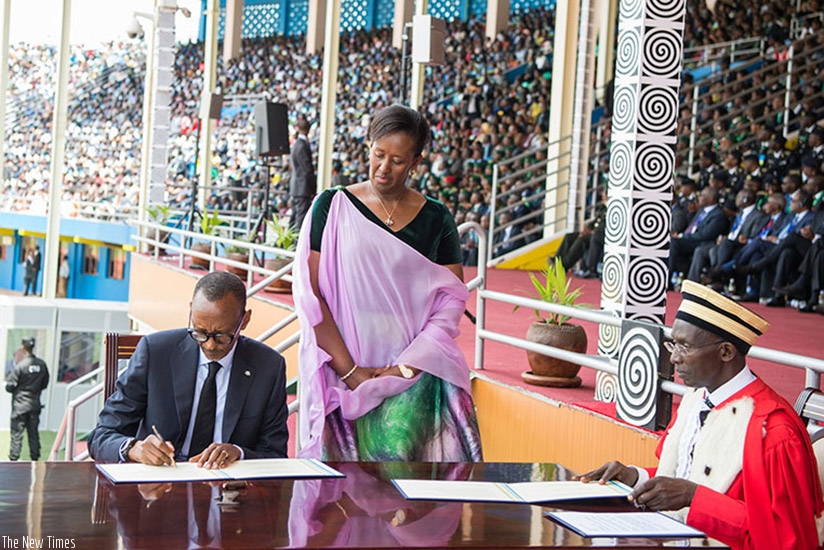 President Kagame signs after taking the presidential oath in the company of First Lady Jeannette Kagame (left) at Amahoro National Stadium in the capital Kigali on Friday, August 18.